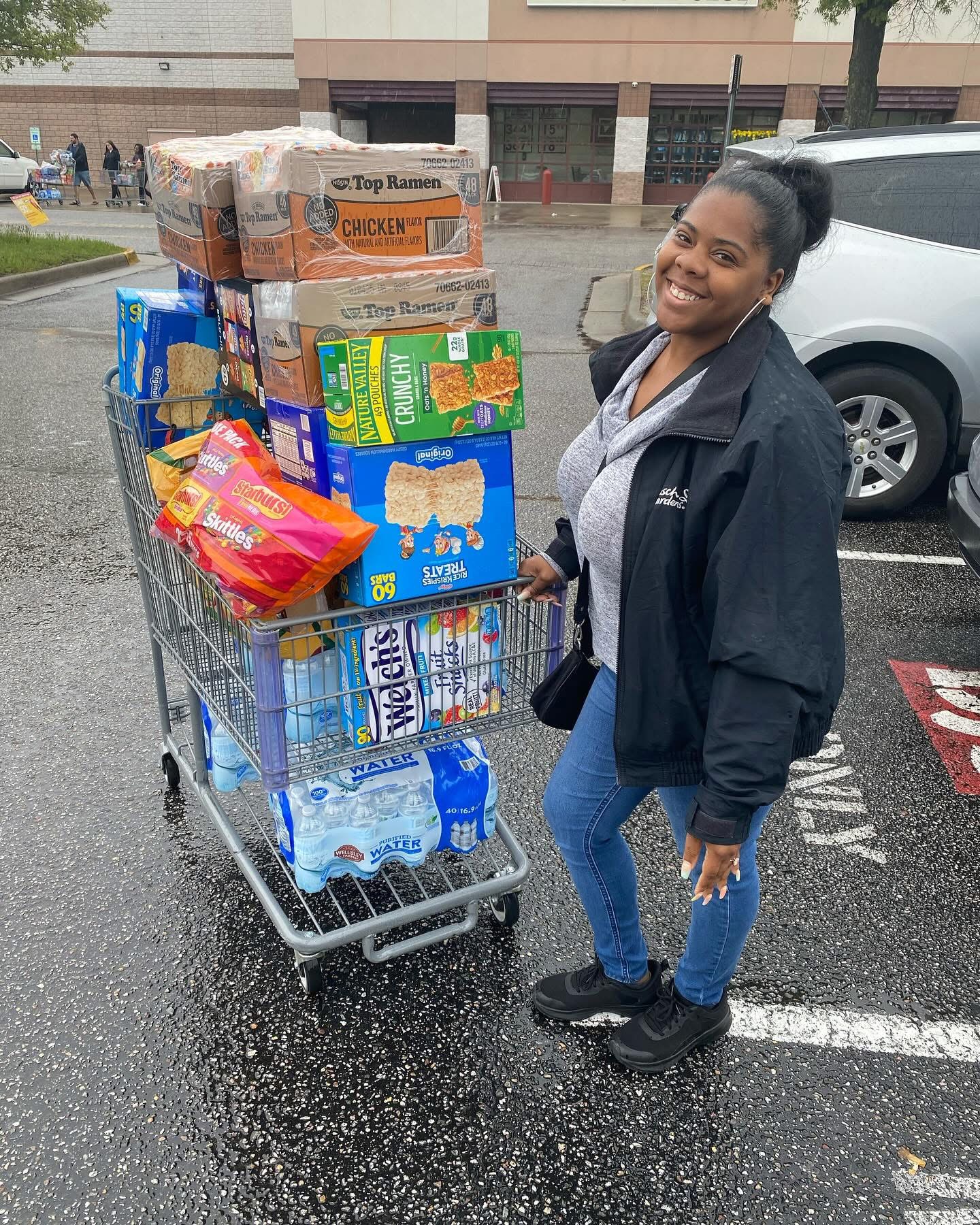 The community service board chair with a cart of supplies for Welcome Home with L.O.V.E.